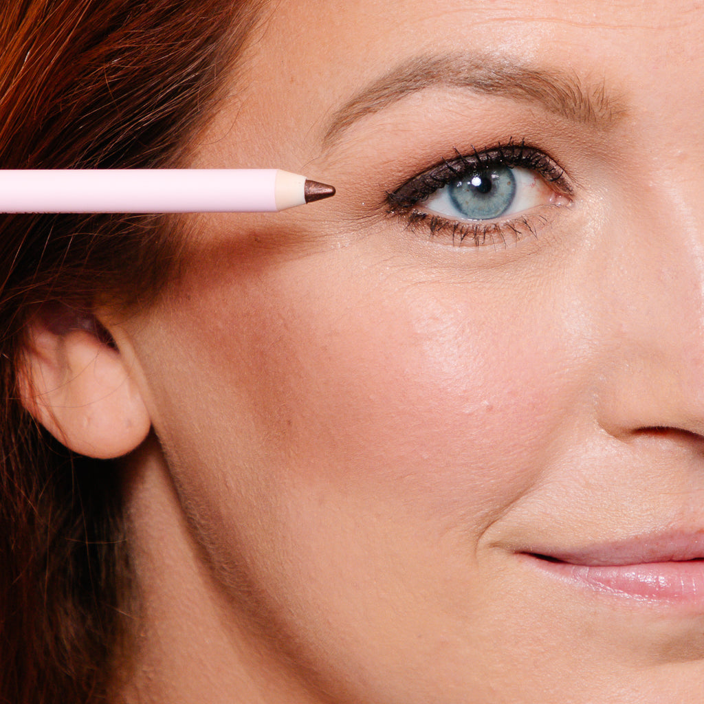 model applying smudge stick to eye