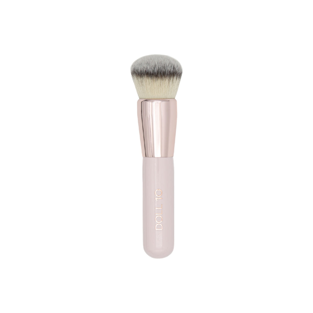 skin buffing brush. Pink handle with rose gold accents. 